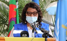 With Dominica flag as background, Dr. C .Etienne speaks at  handover ceremony of PAHO donated vehicles