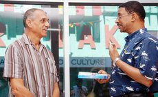 Dr James presents copy of  Alzheimers Advisor to Dr Alwin Bully