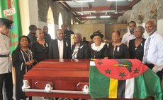 Friends and family of Arnold Active stand behind his coffin