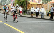 Jyme Bridges crosses the finish line; Andrew Norbert is next