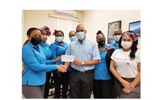 Father Nigel Karam, centre, and staff of Republic Bank