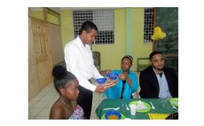 Parliamentary Secretary Joshua Francis serves the children at the dinner