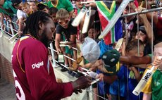 Chris Gayle signs autographs after the game