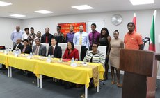 Students and officials pose after the ceremony