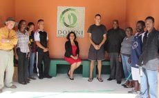 HE Jennifer Aird, sitting , and project stakeholders in buss-stop