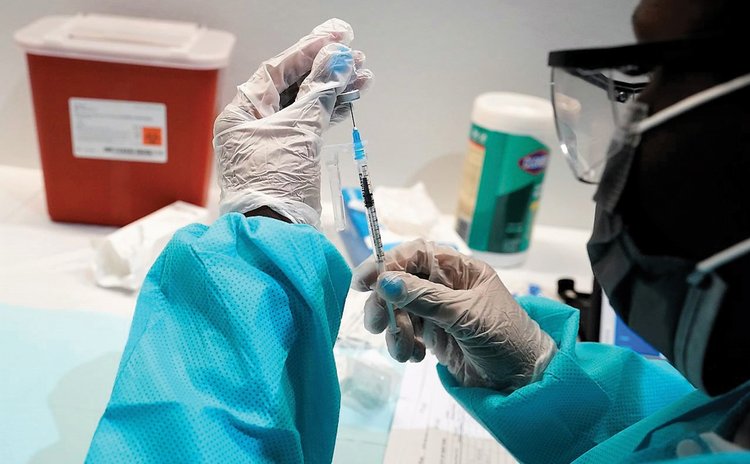 Health provider prepares to administer vaccine