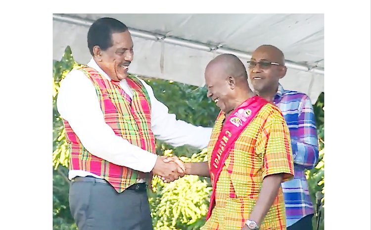 Cultural Elder Henry George receives shash from President Charles Savarin