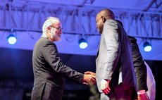 Dr lennox Honychurch greets PM Skerrit after Honychurch receives awaard at Independence Day ceremony 2018
