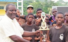 Sports Coordinator Trevor Shillingford hands trophy to the captain of Skinner House