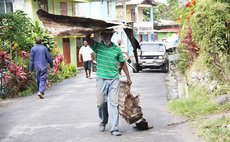 Man caries metal to dump during Zika National Clean up Day