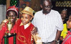 Irish Kid, left, is congratulated after winning the Junior Monarch crown. Song writer Castle, right front looks on