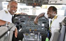 Captain Keith Robertson (left) with his son First Officer Kori Robertson in the flight deck of a LIAT aircraft
