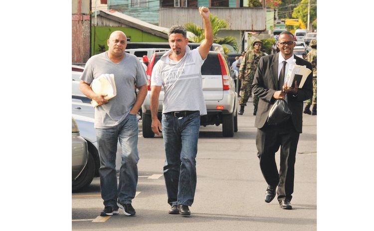 Claudius Sandford, centre, with his lawyers David Bruney, left, and Ronald Charles