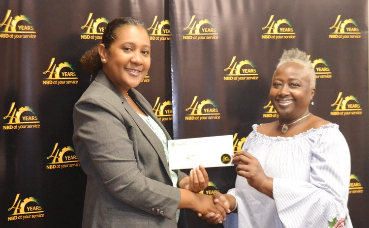Carol Jno Charles, right, receives prize from NBD's Lisa Latouche