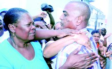 Lugay is embraced by supporters after leaving the magistrate'a court