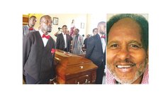 Mac Douglas, right, and relatives carry coffin to burial ground