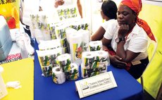Worker at the Nature Island Paper Product booth at the 2015 Creole in the Street expo