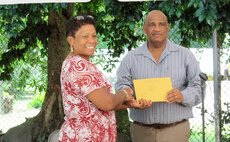 Abraham receives gift from Mrs Savarin, wife of the President of Dominica