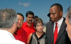 FILE PHOTO: Late Venezuelan President Chavez on first visit to Dominica; current President Maduro in the background