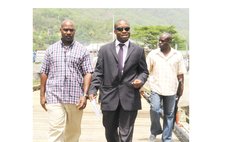 Bertrand, left, and Magistrate Behanzin at the coast guard jetty