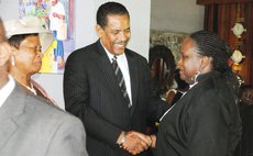 President Savarin greets Judge Stevenson at the inauguration reception of the President