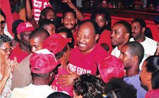 Rosie Dougls greets his supporters at a DLP rally