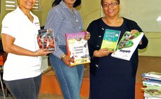 Bank of Nova Scotia officials and right, Principal of the Dominica Grammar School