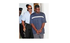 Police officers lead Dagallaire out of court after being charged