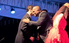 Prime Minister Skerrit hugs Popone, his father-in-law after Popone receives award