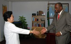 Prime Minister Skerrit, right, greets a Chinese official at his office in 2007
