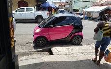 Small car sits on Great George Street in Roseau