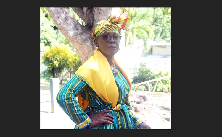 In national dress, Sonia Magloire-Akpa