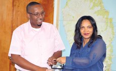 Steve Joseph of Local Government , left , and Gelina Fontaine of Child Fund shake hands at the function