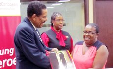 Unsung Herro receives coffee-table book from President Savarin