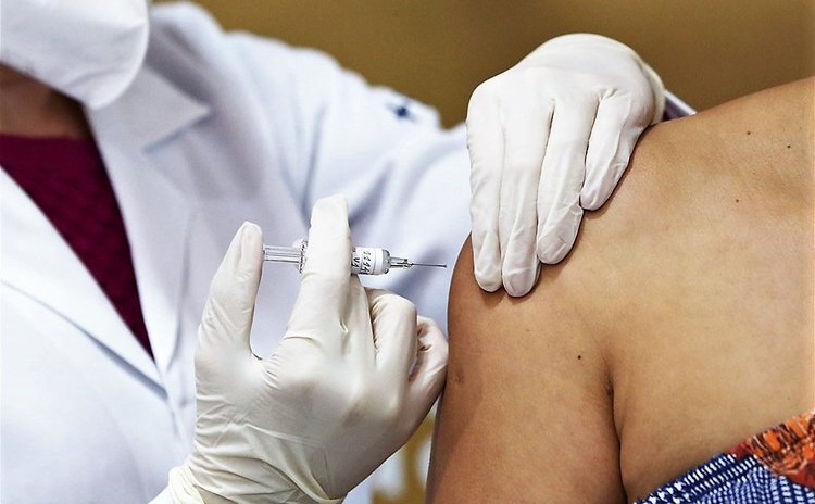 Health professional administering vaccine