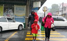 Walking in the rain with the ones we love... near HHV Whitchurch supermarket in Roseau