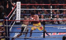   Floyd Mayweather (L) lands a punch on Manny Pacquiao (R) in the eighth round during their welterweight WBO, WBC and WBA (Super) title fight in Las Vegas, Nevada, May 2, 2015. (Xinhua/Marcel Thomas) 