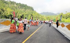 People attending opening ceremony walk on the new York Valley Bridge