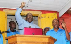 Rosemond Edwards, Financial Secretary signs for the Government of Dominica and Mohaammed for Range Developments; PM Skerrit looks on